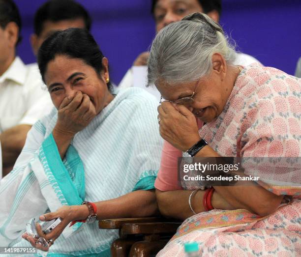 Railways Minister Mamata Banerjee with Delhi Chief Minister Sheila Dikshit enjoy a light moment during the flagging-off ceremony of a special train...