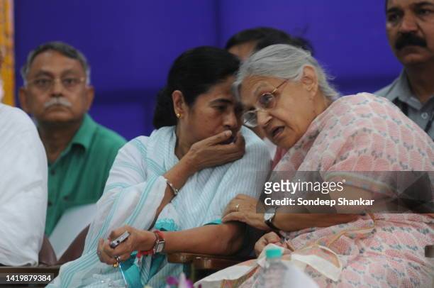 Railways Minister Mamata Banerjee with Delhi Chief Minister Sheila Dikshit enjoy a light moment during the flagging-off ceremony of a special train...