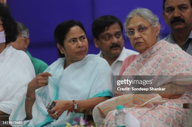 Railways Minister Mamata Banerjee with Delhi Chief Minister Sheila Dikshit enjoy a light moment during the flagging-off ceremony of a special train...