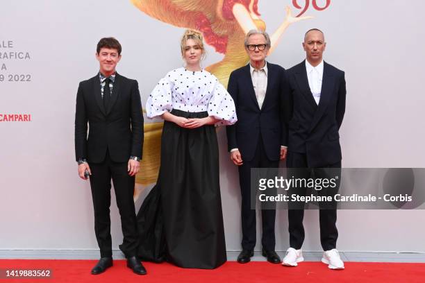 Alex Sharp, Aimee Lou Wood, Bill Nighy and director Oliver Hermanus attend the "Living" red carpet at the 79th Venice International Film Festival on...