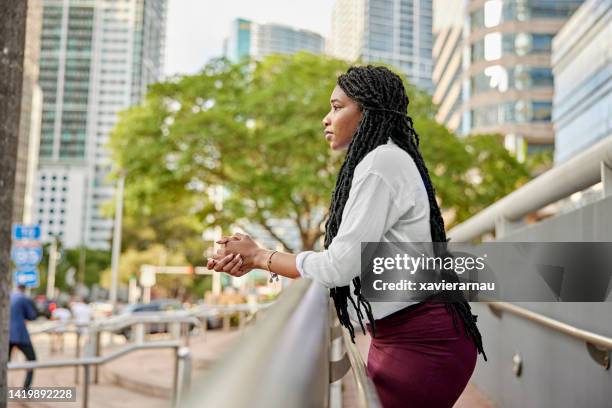 contemplative young businesswoman taking a break - leaning on elbows stock pictures, royalty-free photos & images