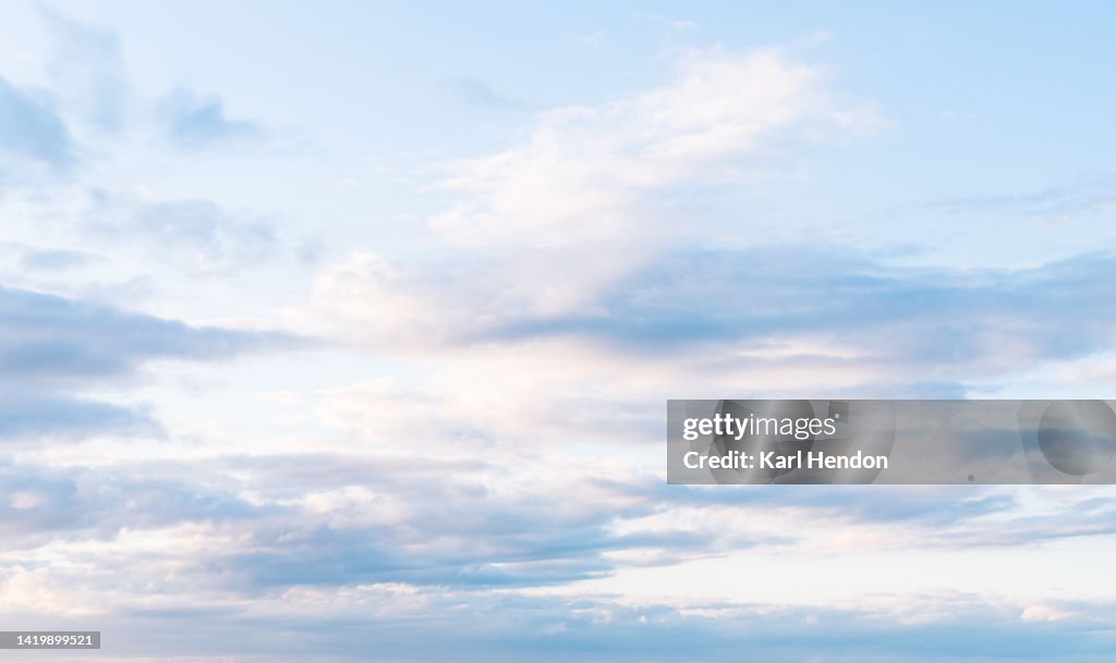 A view of pink fluffy clouds at sunset
