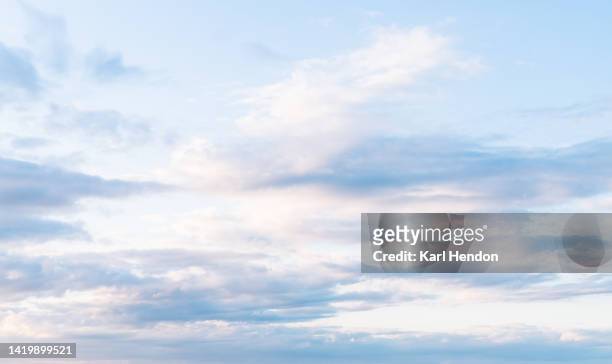 a view of pink fluffy clouds at sunset - sky only stock pictures, royalty-free photos & images