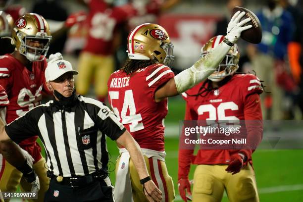 Fred Warner of the San Francisco 49ers holds the ball in the air during NFL game against the Buffalo Bills on December 07, 2020 in Glendale, Arizona.