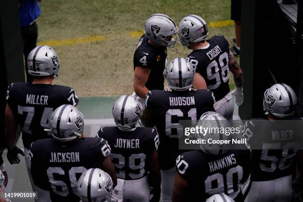 Derek Carr of the Las Vegas Raiders bumps heads with defensive end Maxx Crosby prior to an NFL game against the Indianapolis Colts on December 13,...