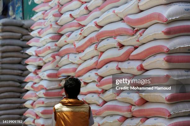 Yemeni man stands near grain bags owned by a merchant are prepared for sale at a market on September 01 in Sana'a, Yemen. Yemen has obtained the...