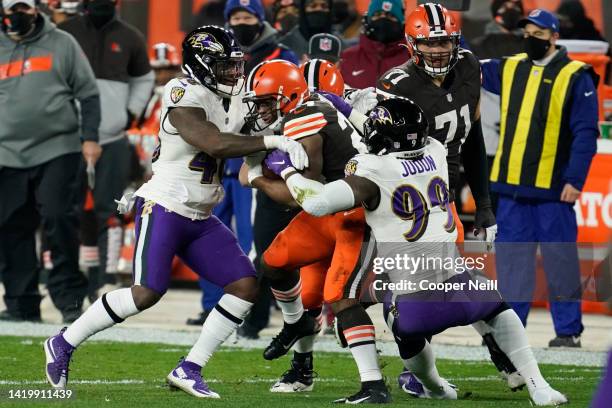 Morgan Cox of the Baltimore Ravens and linebacker Matthew Judon tackle Nick Chubb of the Cleveland Browns during an NFL game against the Cleveland...