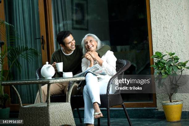 man with senior mother at home - son in law stock pictures, royalty-free photos & images