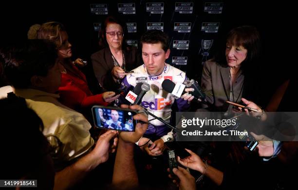 Driver Denny Hamlin speaks with the media during the NASCAR Cup Series Playoff Media Day at Charlotte Convention Center on September 01, 2022 in...