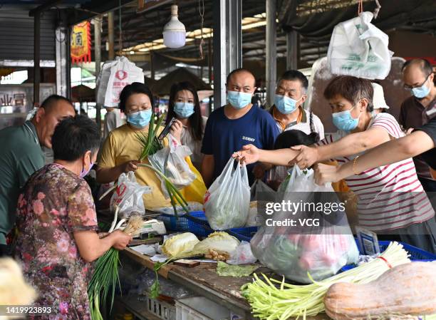 Shoppers are seen at a wet market as Chengdu imposes city-wide static control to curb new COVID-19 outbreak on September 1, 2022 in Chengdu, Sichuan...