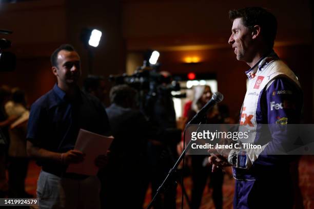 Driver Denny Hamlin speaks with the media during the NASCAR Cup Series Playoff Media Day at Charlotte Convention Center on September 01, 2022 in...