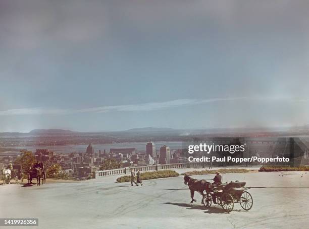 View from the Mount Royal lookout of the city of Montreal on the St Lawrence River in the province of Quebec in Canada circa 1950. In background on...