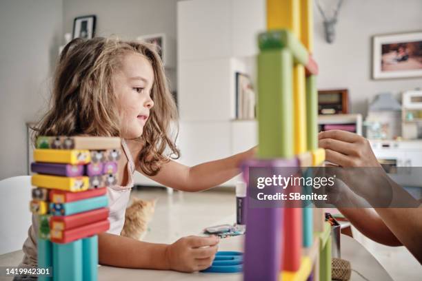 cute spanish children playing with blocks - jugar fotografías e imágenes de stock