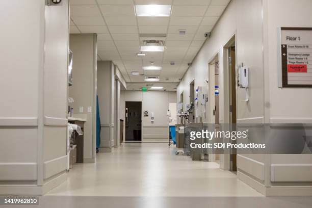 view down hallway of emergency department in hospital - hospital corridor stock pictures, royalty-free photos & images