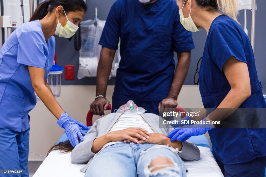 Unconscious young woman brought into ER