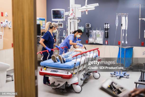 view through open door of emergency examination room - acute care stock pictures, royalty-free photos & images