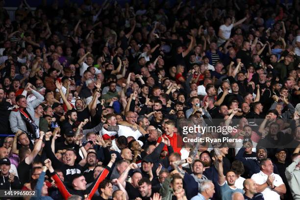 Manchester United fans celebrate their side's first goal scored by Jadon Sancho of Manchester United during the Premier League match between...