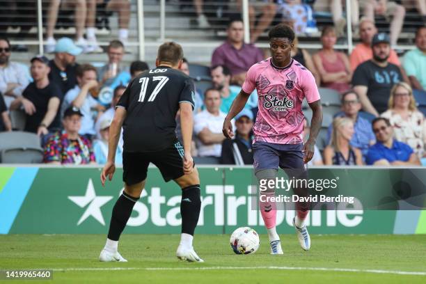 Demarai Gray of Everton dribbles the ball while Robin Lod of Minnesota United defends in the first half of an international friendly at Allianz Field...