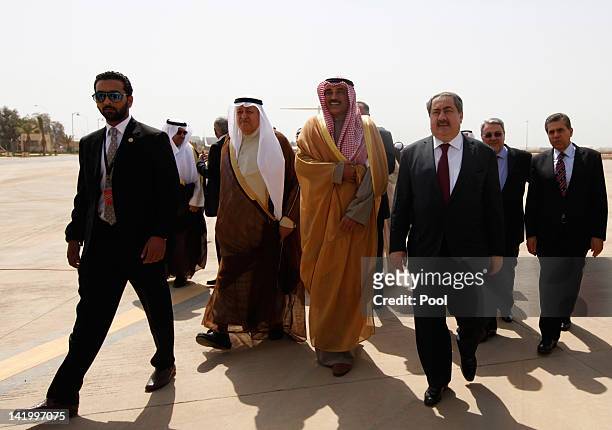 Iraq's Foreign Minister Hoshyar Zebari walks with his Kuwaiti counterpart Sheikh Sabah Khalid Al-Hamad Al-Sabah upon his arrival for the Arab foreign...