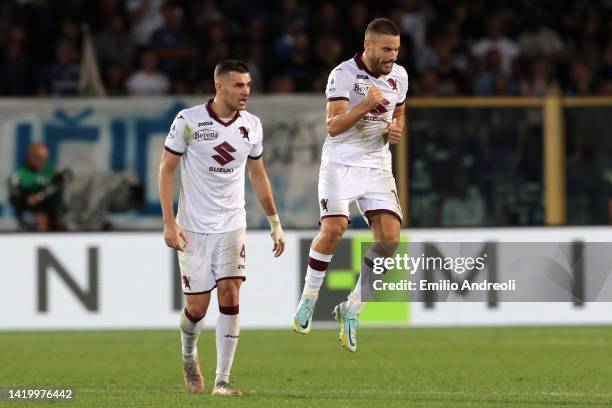 Nikola Vlasic of Torino FC celebrates with teammate Alessandro Buongiorno after scoring their side's first goal during the Serie A match between...