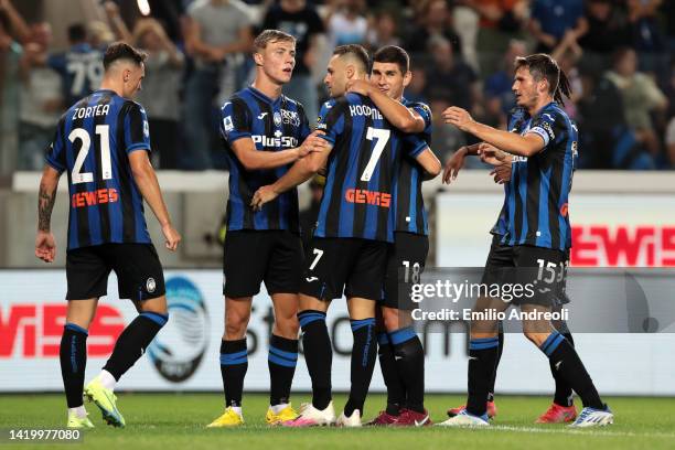 Teun Koopmeiners of Atalanta BC celebrates with teammates after scoring their side's third goal from the penalty spot during the Serie A match...