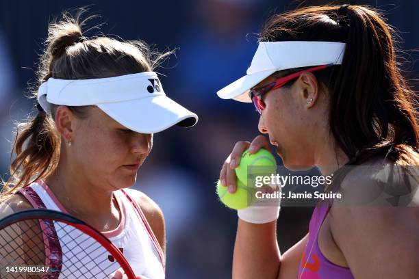 Xinyun Han of China and Evgeniya Rodina talk strategy during their Women's Doubles First Round match against YiFan Xu of China and Zhaoxuan Yang of...