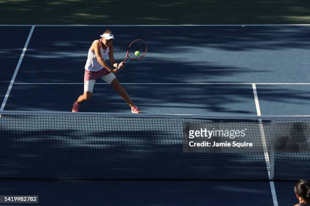 Evgeniya Rodina returns a shot with partner Xinyun Han of China during their Women's Doubles First Round match against YiFan Xu of China and Zhaoxuan...