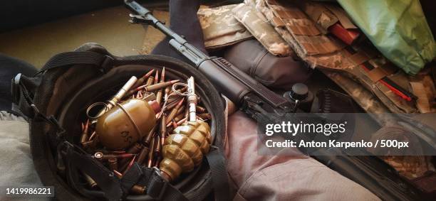 high angle view of handgun and bullets on leather bag,ukraine - ak 47 stock pictures, royalty-free photos & images