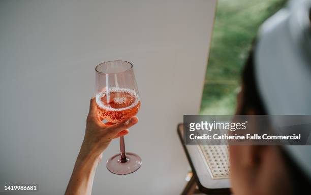 a woman indulges in a glass of champagne during a spa session. - champagne salon stock-fotos und bilder