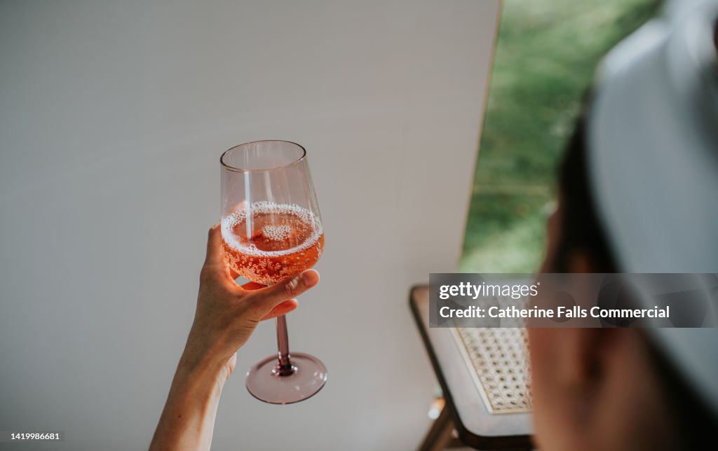 A woman indulges in a glass of champagne during a spa session.