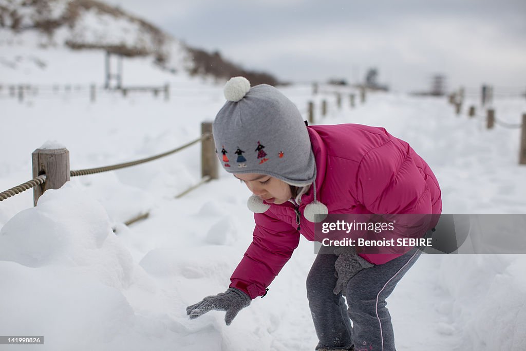 Japanese girl playing in snow