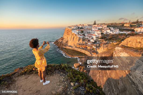 tourist taking photo in azenhas do mar - sintra portugal stock pictures, royalty-free photos & images