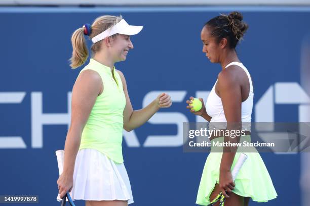 Leylah Fernandez of Canada and Daria Saville of Australia confer during their Women's Doubles First Round match against Coco Gauff of the United...