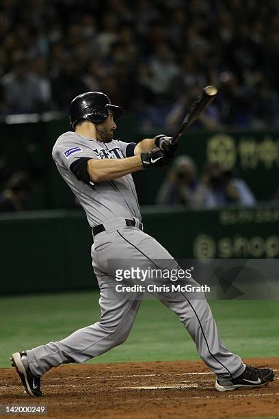 Dustin Ackley of the Seattle Mariners hits a single to get home team mate Brendan Ryan in the 11th inning against the Oakland Athletics during the...