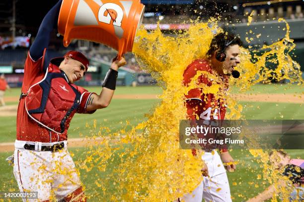 Joey Meneses of the Washington Nationals gets doused with Gatorade by Tres Barrera after hitting the game winning three-run home run in the tenth...