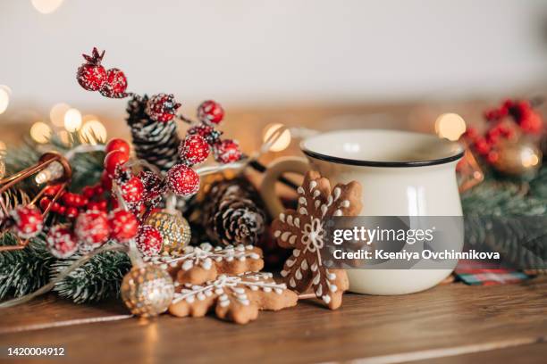 white ceramic tea mug mockup with winter xmas decorations and copy space for your design. front view 10oz cup background for christmas promotional content. - mug mockup stock pictures, royalty-free photos & images