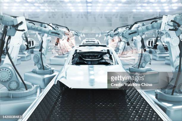 cars on futuristic assembly automotive manufacturing line - tesla factory stock pictures, royalty-free photos & images