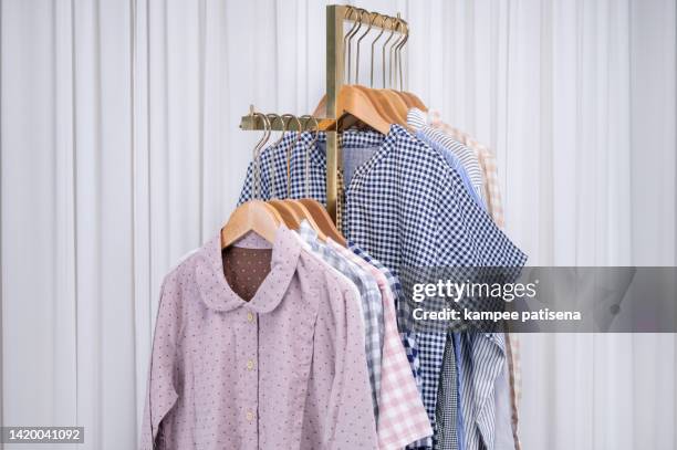 group of pajamas hanging in home - roupa de dormir - fotografias e filmes do acervo