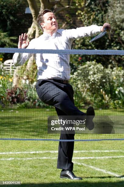 British Prime Minister David Cameron plays a game of badminton with school athletes and London 2012 Organising Committee chairman Sebastian Coe in...
