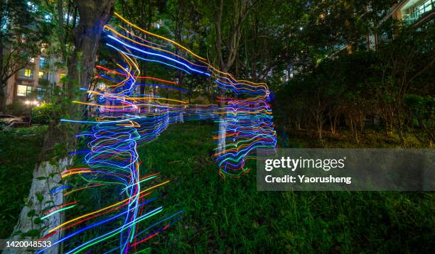 light painting in the forest at night - circus lights stock pictures, royalty-free photos & images