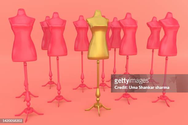 golden mannequin stand out in a group of pink mannequins - group fashion show ストックフォトと画像
