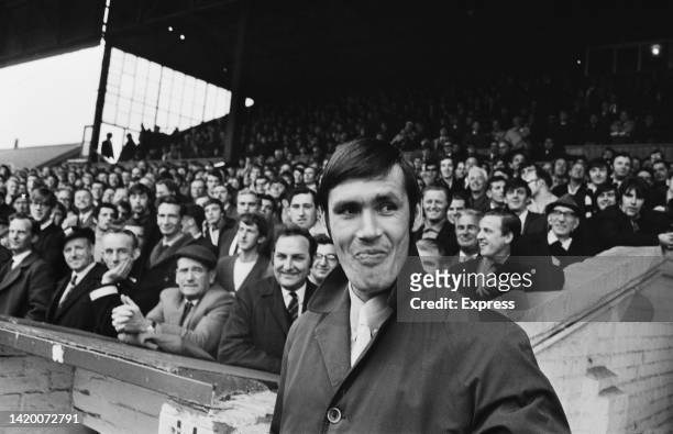 British footballer Tony Hateley , Notts County striker, standing with the Notts County fans as they watch the English League Division Four match...