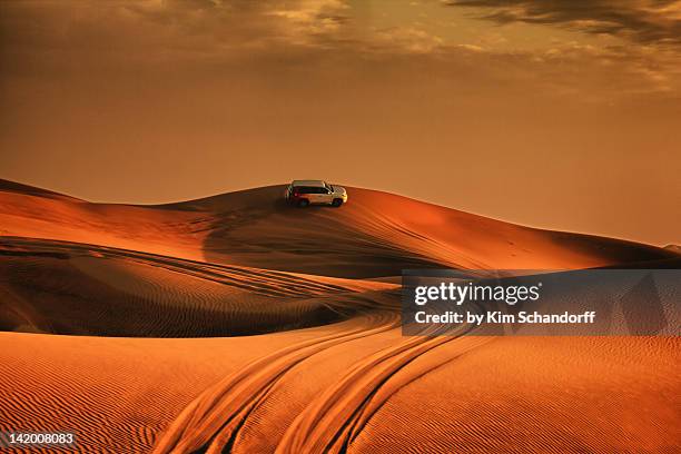 driving over sand dunes - dubai sunset desert stock pictures, royalty-free photos & images