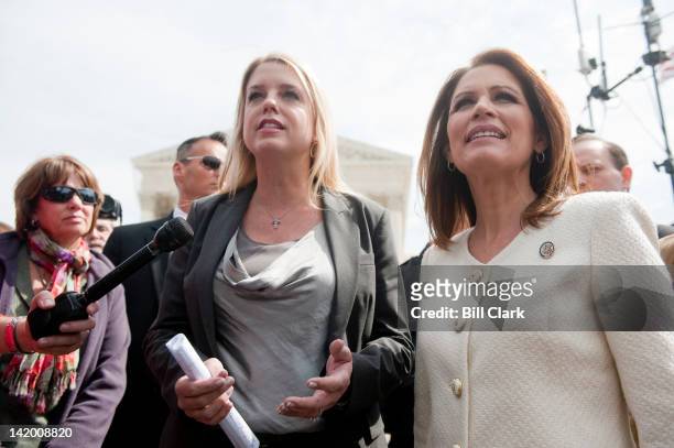 Florida Attorney General Pam Bondi, left, and Rep. Michele Bachmann, R-Minn., speak to the media as Bachmann leaves the Supreme Court on day 3 of...
