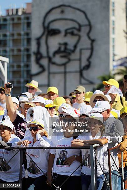People watch as Pope Benedict XVI conducts his mass at Havana's Revolution Square on the last day of his three day visit on March 28, 2012 in Havana,...