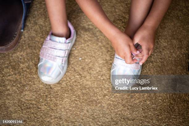 girl putting on her shiny shoes - sparkle shoes stock pictures, royalty-free photos & images