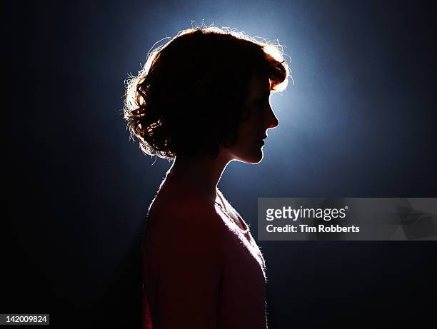 silhouette of young woman. - in silhouette stock-fotos und bilder