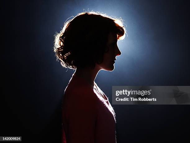 silhouette of young woman. - backlit photos et images de collection