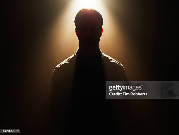 young man in silhouette. - kontur stock-fotos und bilder