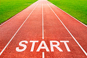 Start written on starting line on of running track of sports field